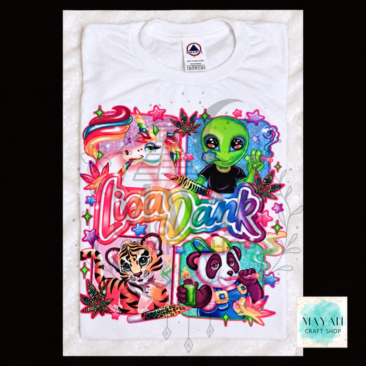 A white short-sleeve t-shirt with a highly colorful, layered graphic design featuring cartoon characters and text. The graphic includes a green alien, a rainbow unicorn, a tiger, a panda, and words in a bubbly multicolor font.