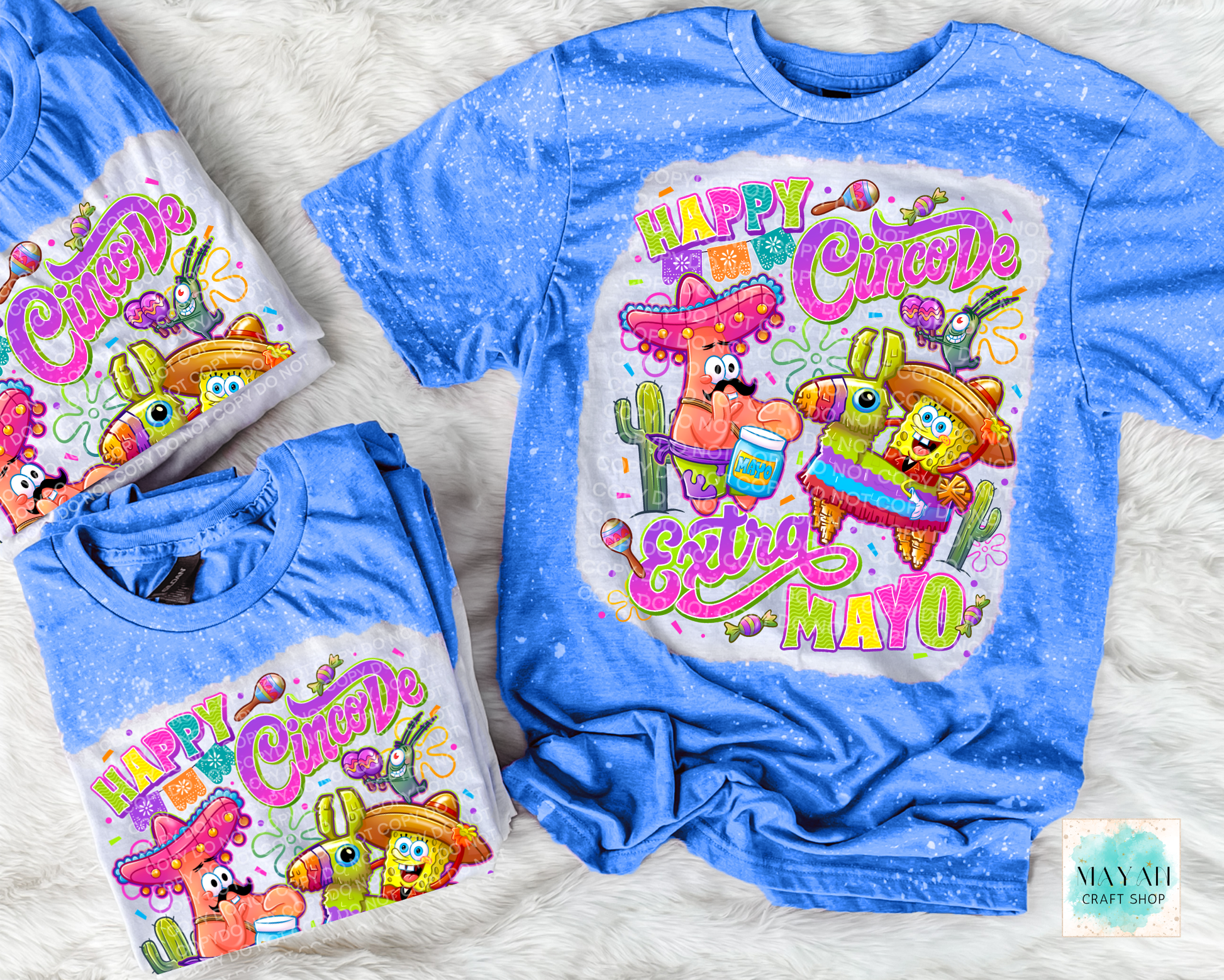 Blue t-shirt with 'Happy Cinco De Mayo' design featuring cartoon characters on a textured surface.