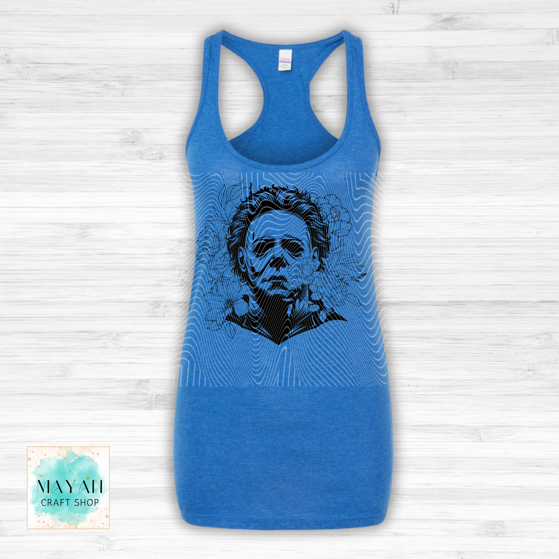 Blue tank top with a graphic design on a wooden surface.