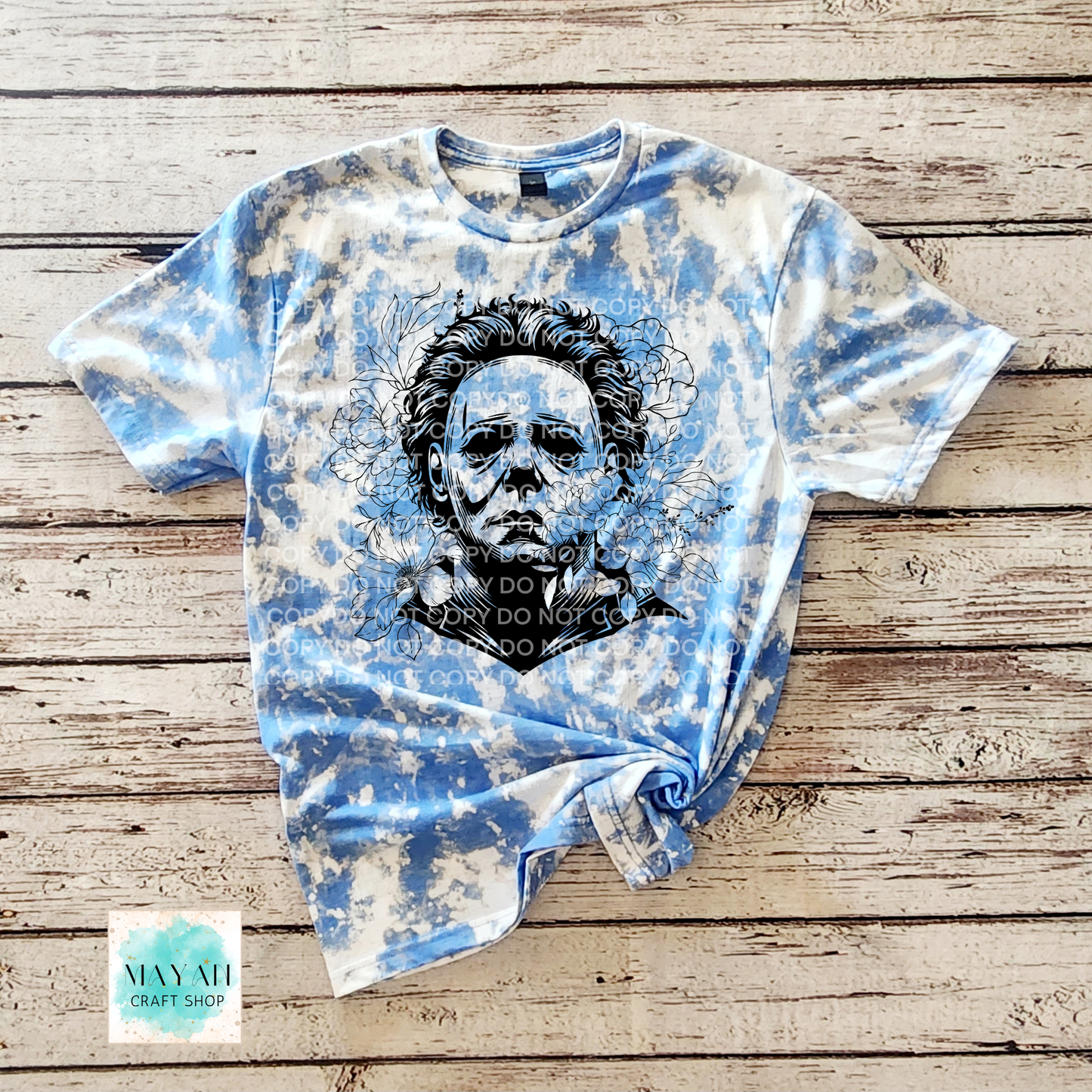 Bleached t-shirt with graphic design on a wooden surface.
