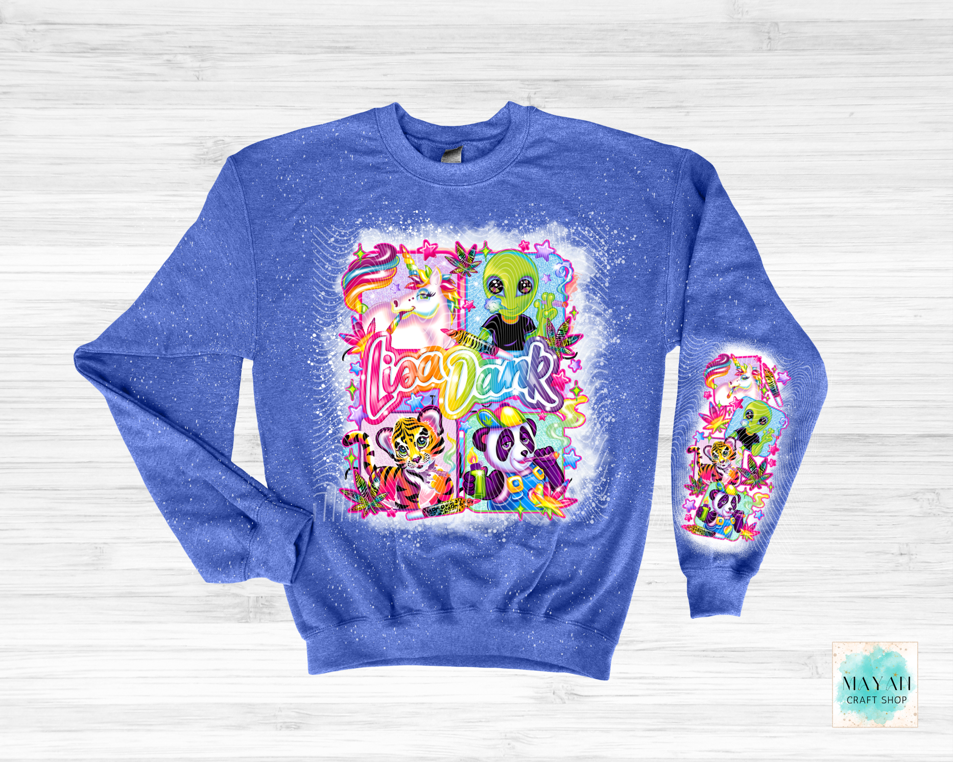 Blue sweatshirt with colorful graphic design on a white wooden background