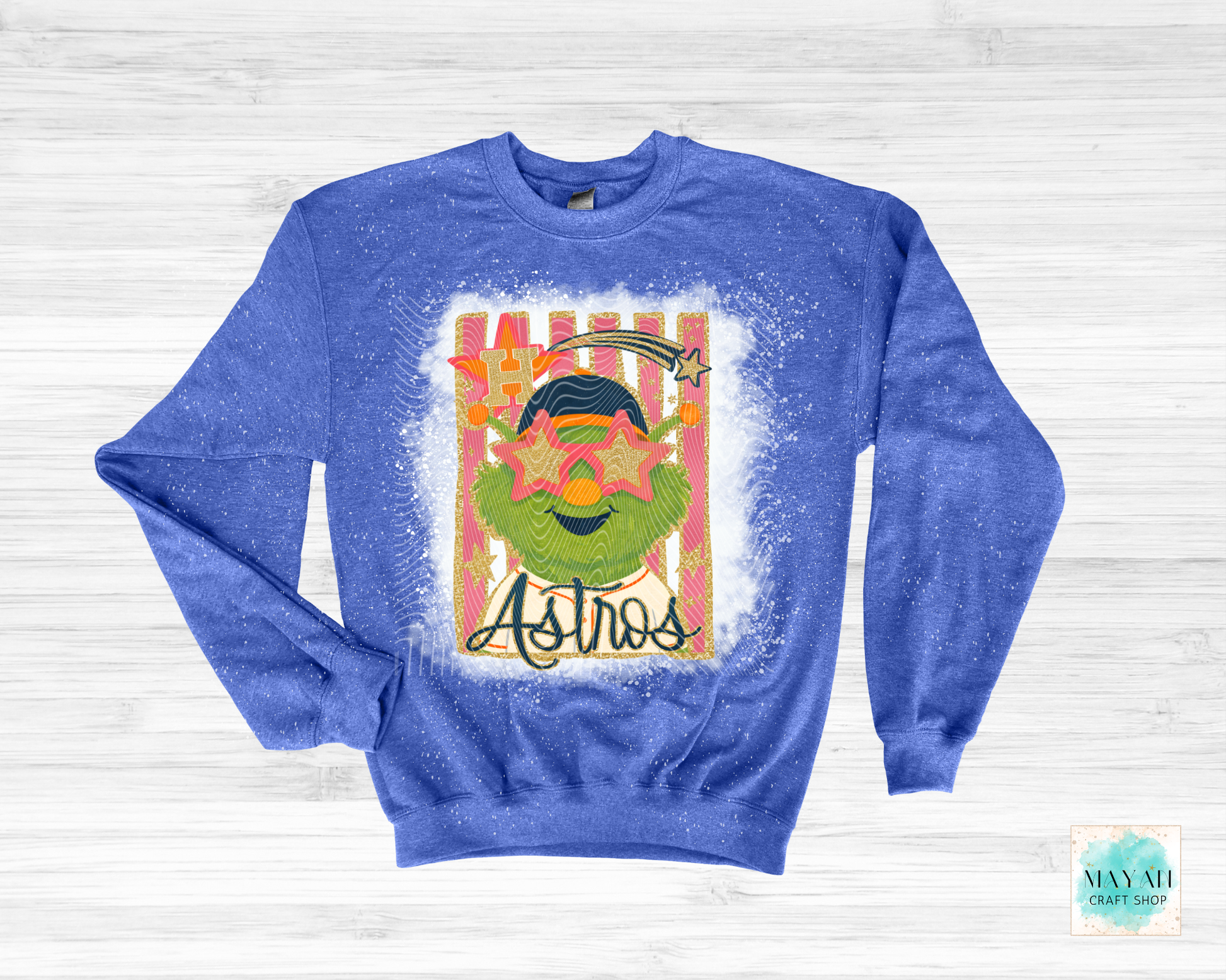 Blue sweatshirt with a graphic design on a white wooden background