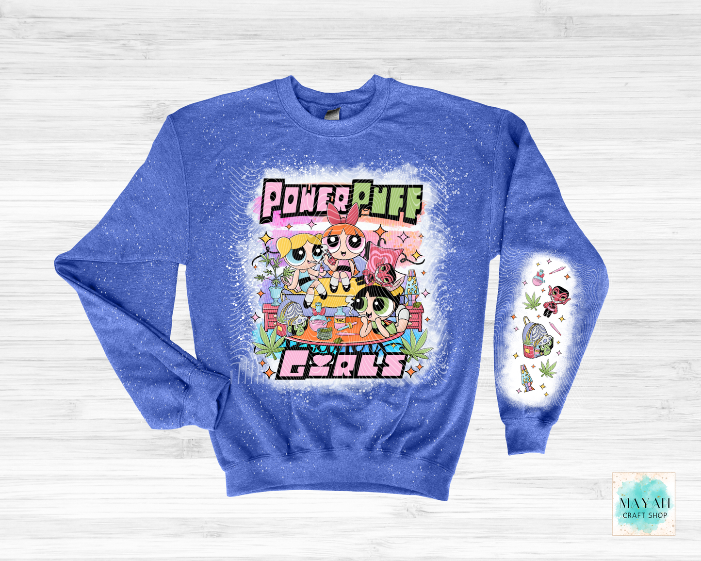 Blue sweatshirt with vibrant graphic on a light wooden background