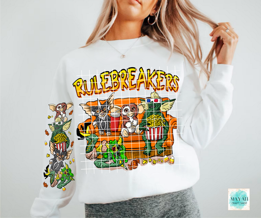 White sweatshirt with 'Rulebreakers' graphic design featuring characters and text.