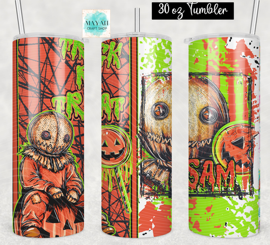 Three views of a 30 oz skinny tumbler with a Halloween-themed wrap design featuring a creepy scarecrow, a stitched face, a jack-o'-lantern. The design has a distressed, grunge aesthetic with orange, green, and brown tones.