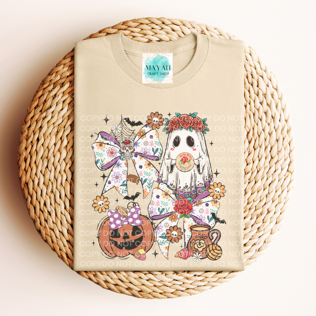 Beige t-shirt with Halloween-themed design featuring ghosts and pumpkins on a woven surface.