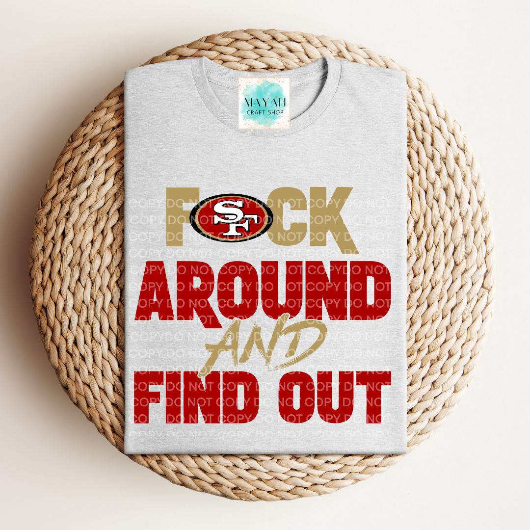 Gray t-shirt with colorful text and logo on a woven surface