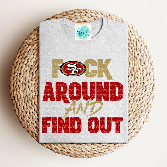 Gray t-shirt with colorful text and logo on a woven surface