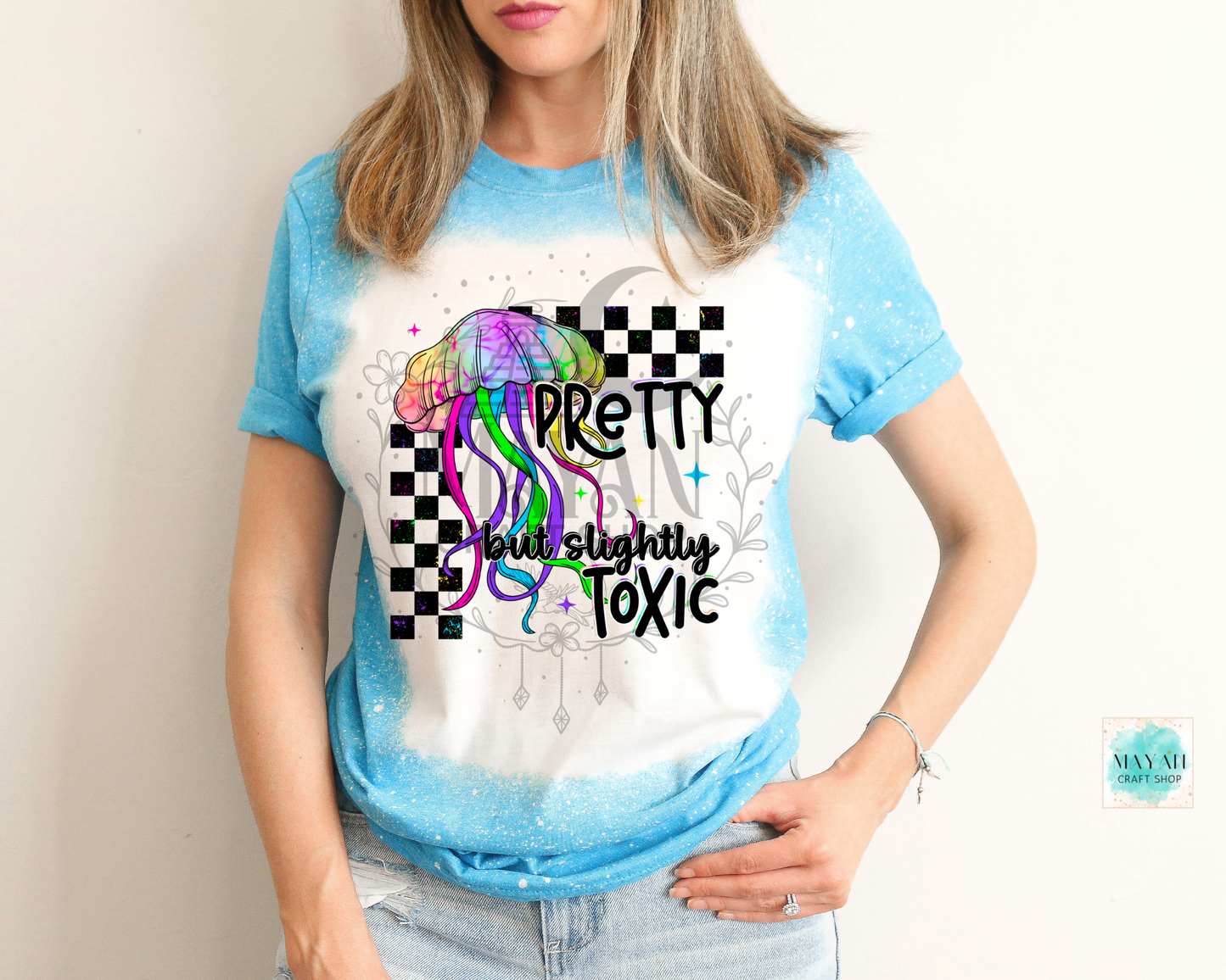 Person wearing a t-shirt with a colorful design and text.