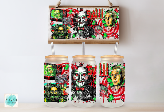 Three frosted glass can-shaped tumblers with bamboo lids and metal straws, displayed below a matching rectangular canvas print featuring a horror-themed collage with skulls, faces.