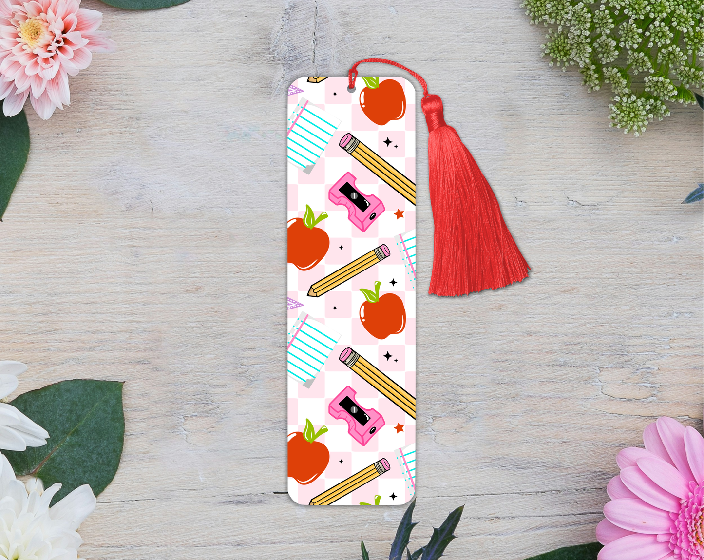 Bookmark with colorful design on a wooden surface with flowers