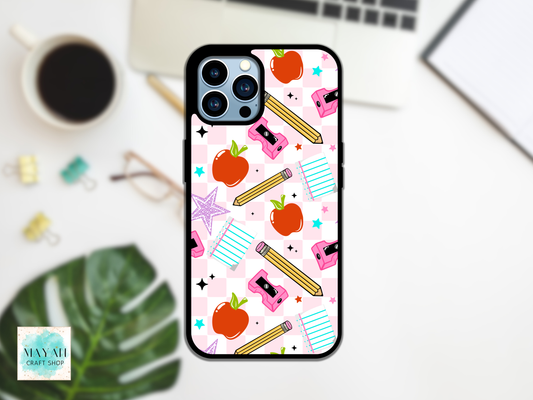 Phone case with school-themed design on a desk with a laptop and coffee cup.
