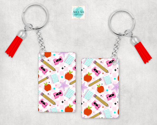 Two keychains with colorful patterns and tassels on a light gray background