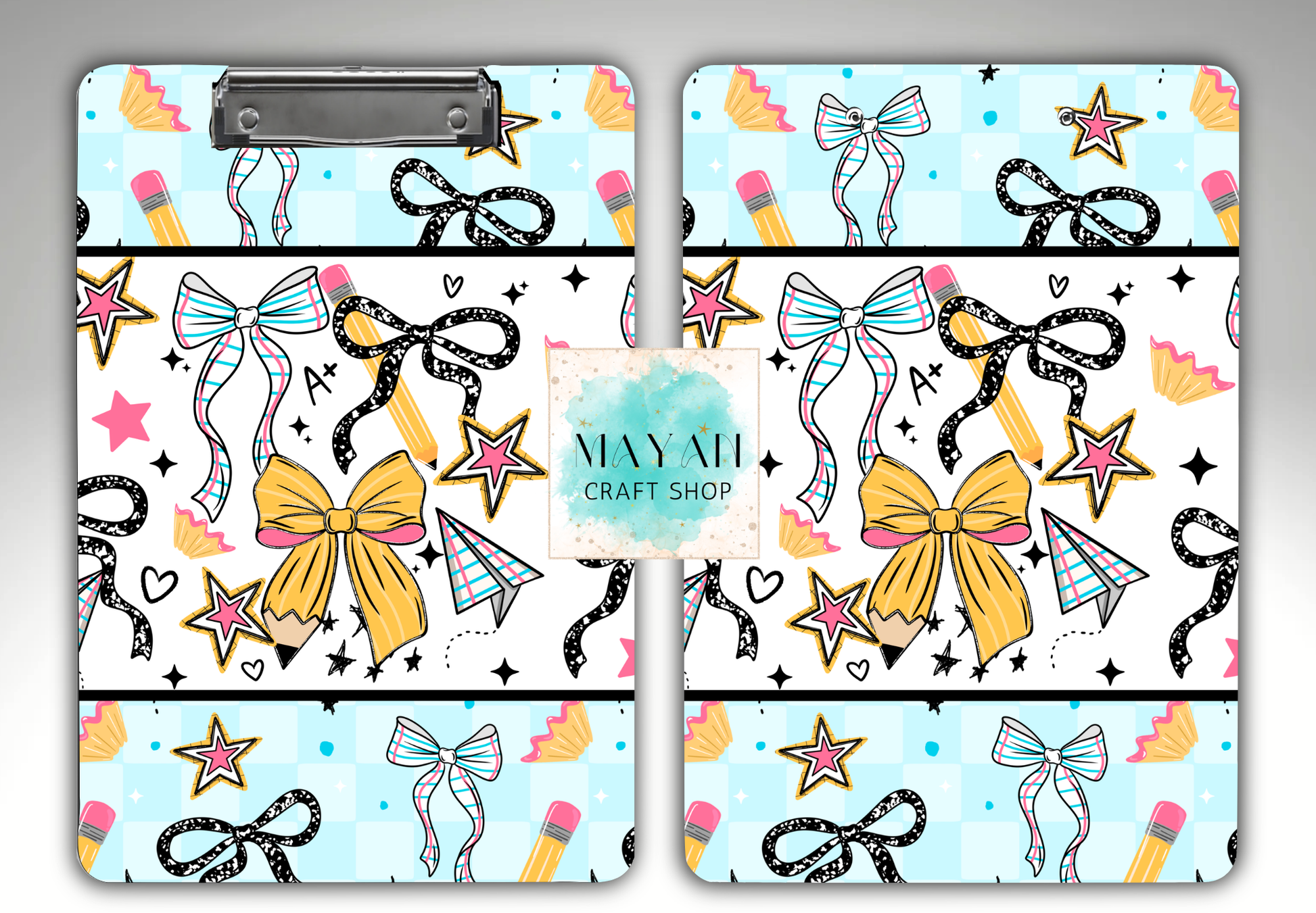Two matching clipboard-style art boards with a repeating craft-themed pattern of bows, stars, pencils, hearts, and small geometric shapes on a light blue background. 