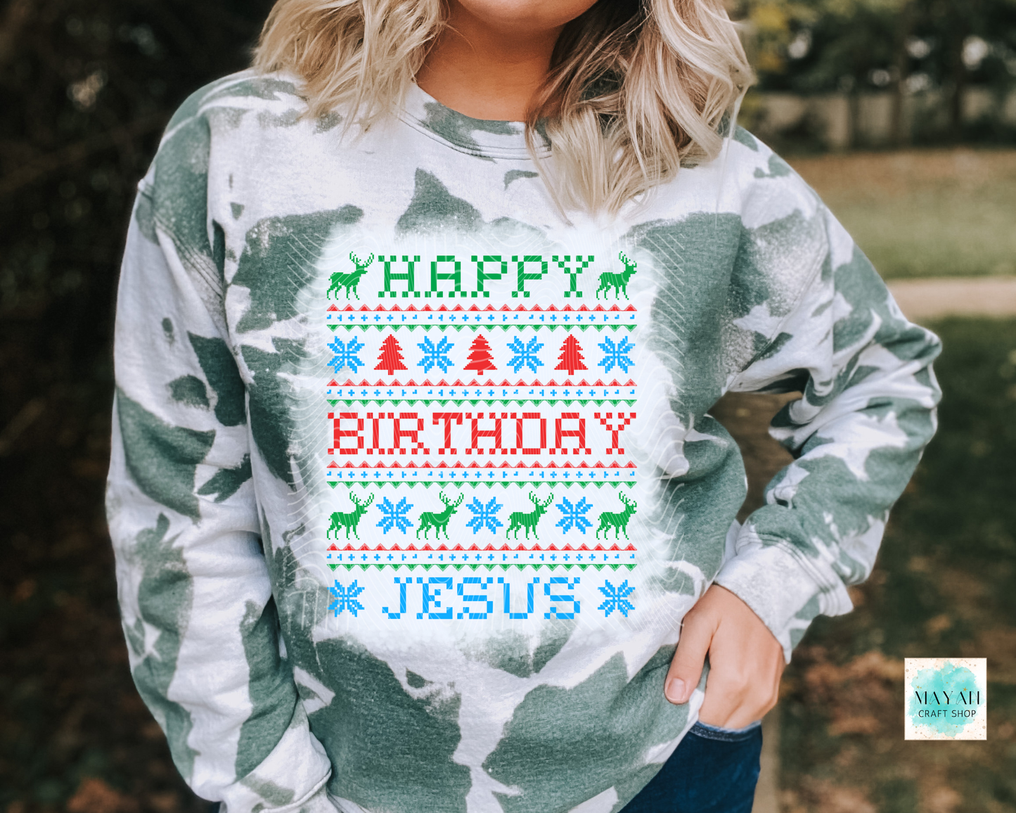 Person wearing a sweater with 'Happy Birthday Jesus' text and Christmas-themed graphics.