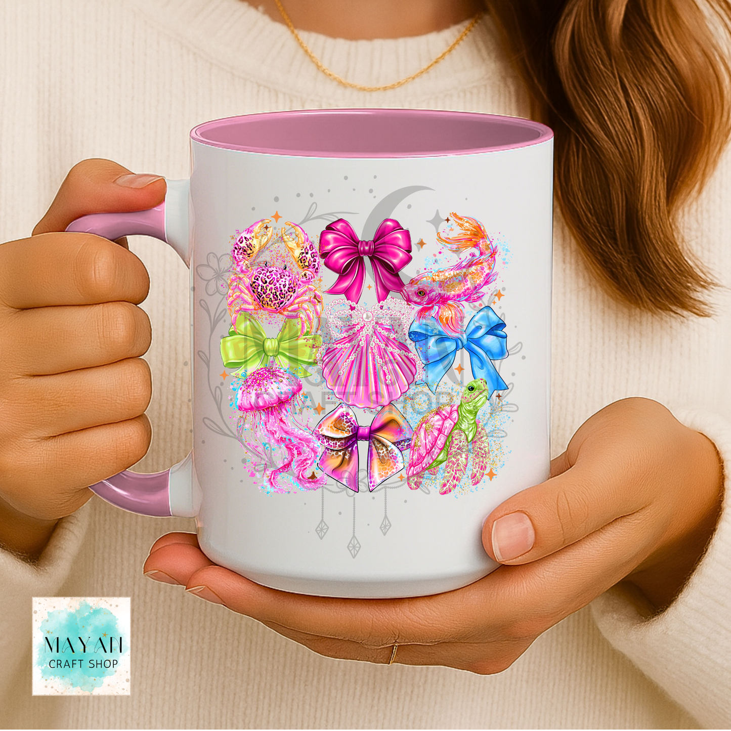 Person holding a mug with colorful designs.