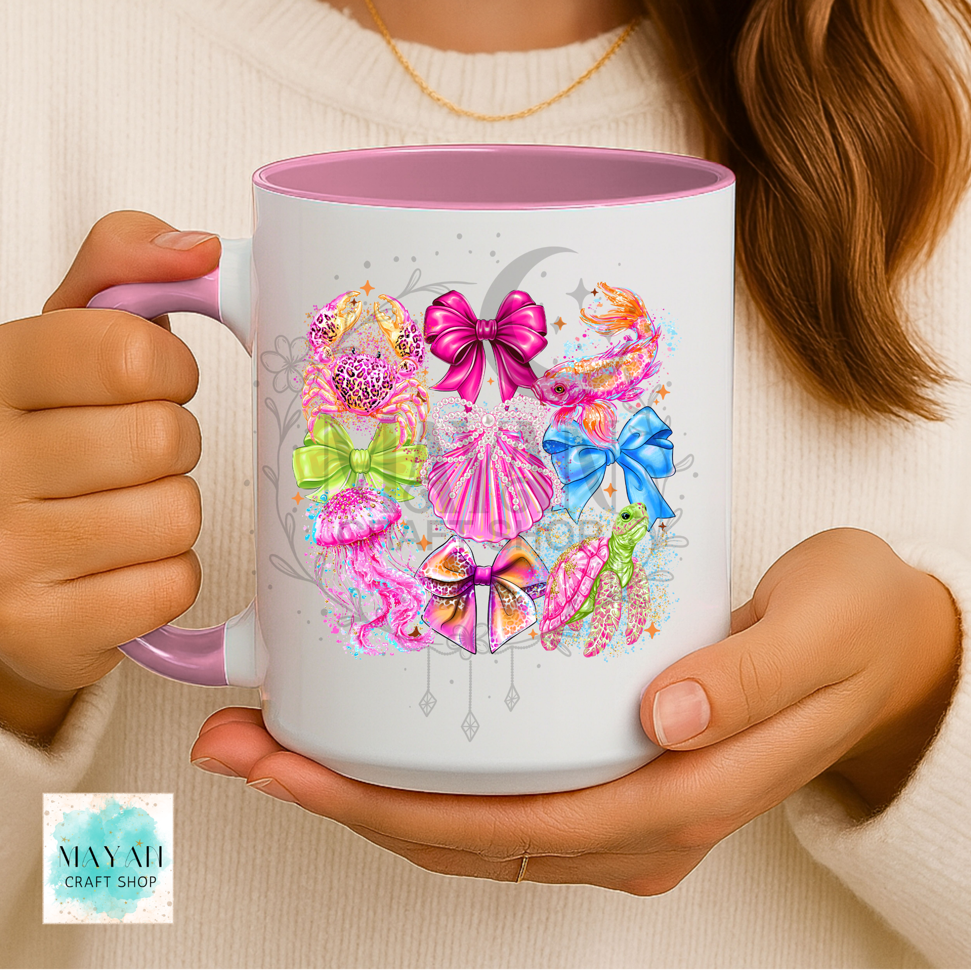 Person holding a mug with colorful designs.