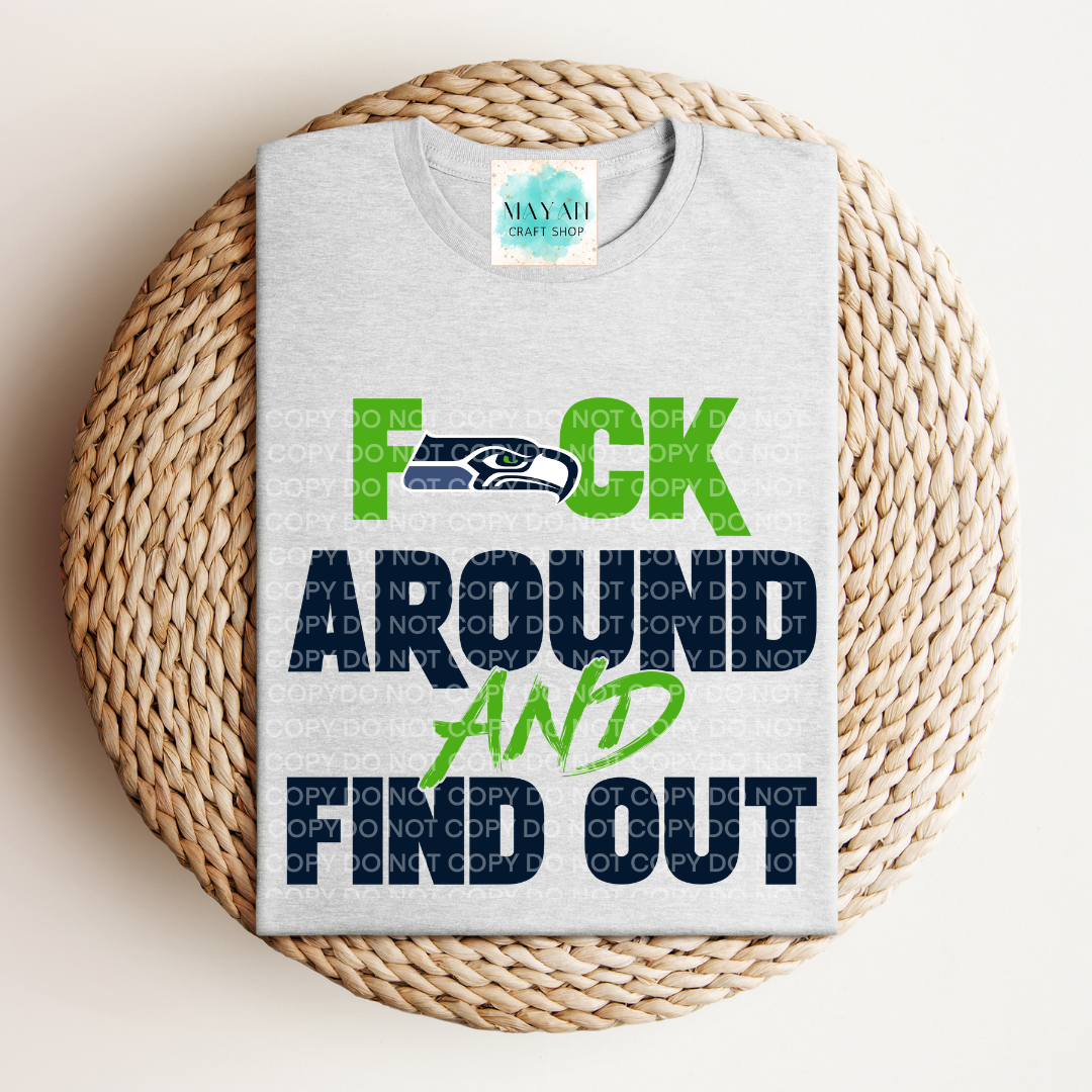 Gray t-shirt with colorful text and logo on a woven surface