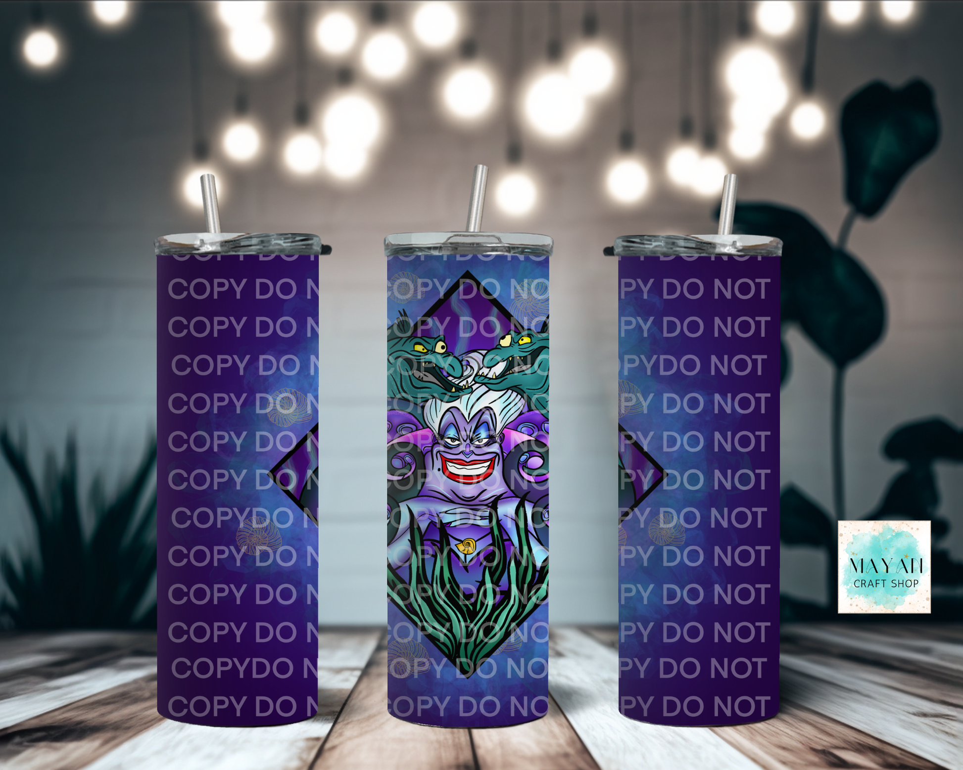 Three purple tumblers with a cartoon character design on a wooden surface with blurred lights in the background.