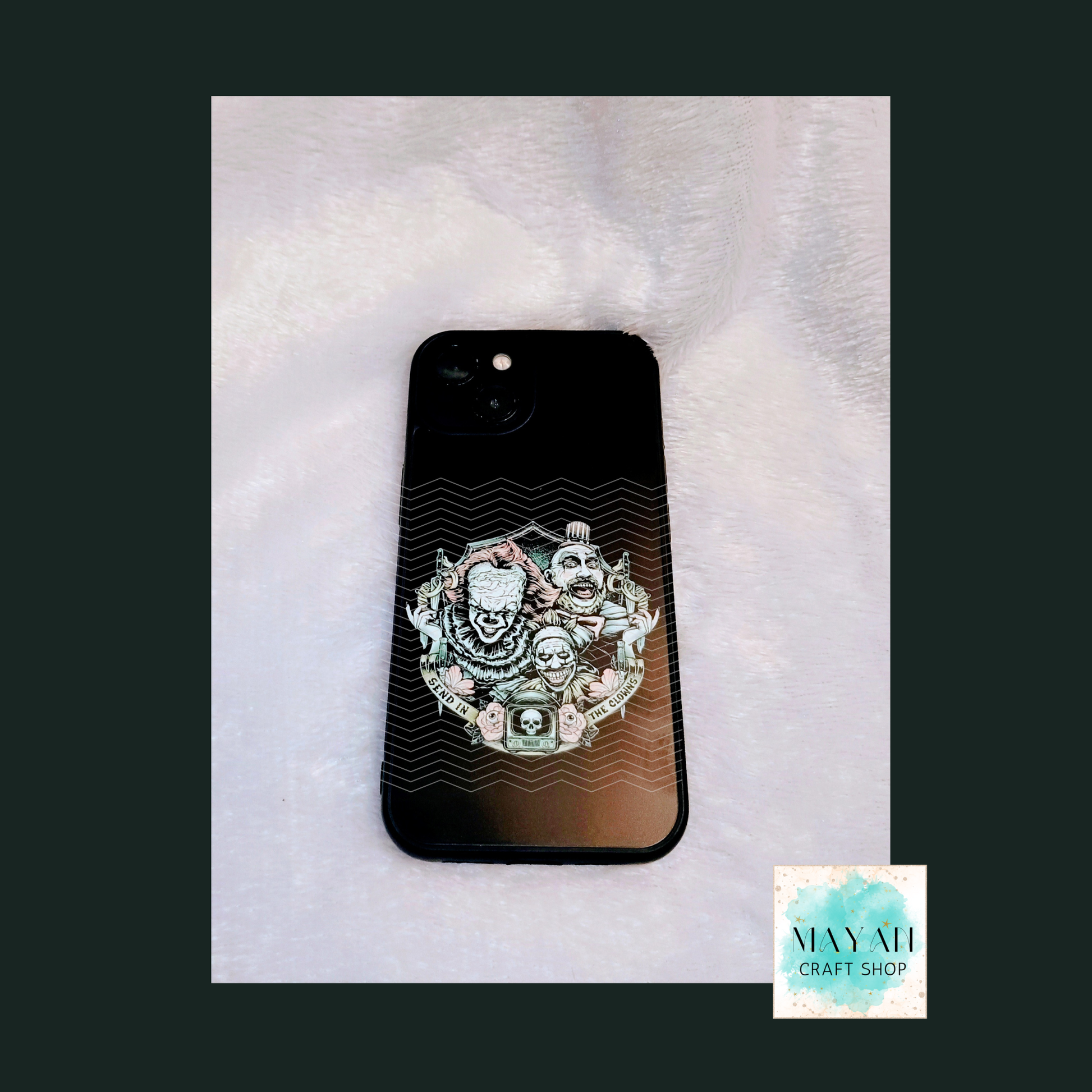 Phone case with decorative design on a textured surface.