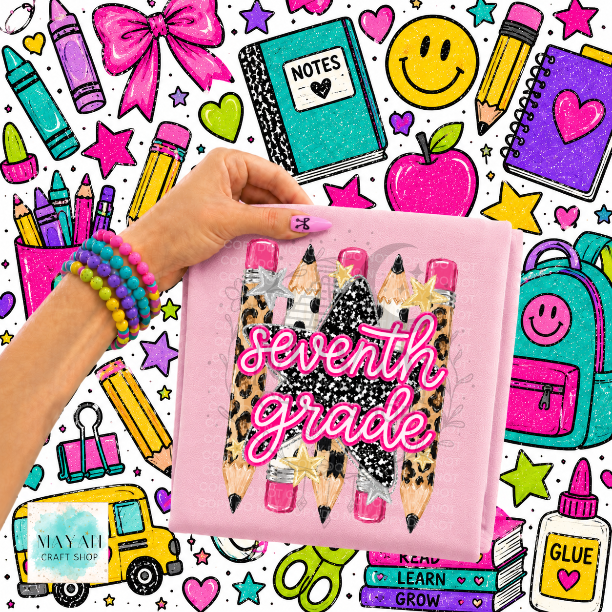 A hand holds a pink shirt cover featuring three glittery pencils with leopard print and pink tips, overlaid with the words 'seventh grade' in pink glittery script. The background is a busy, colorful school-themed graphic pattern with crayons, notebooks, stars, and icons.