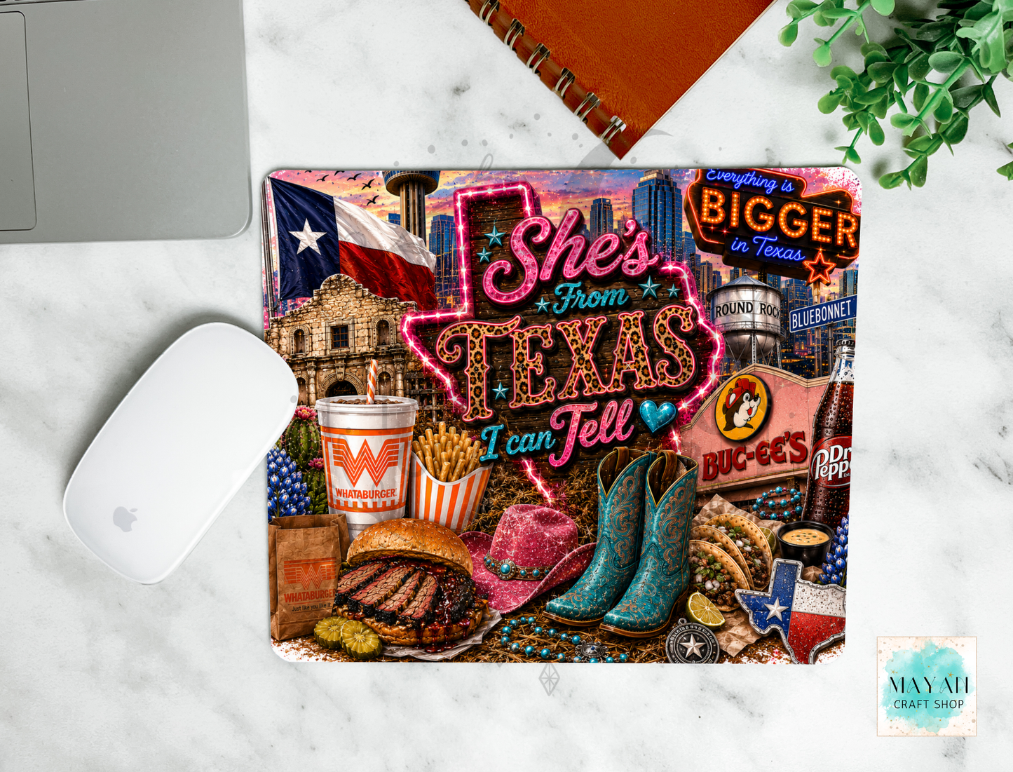 Colorful mouse pad with Texas-themed design on a marble surface.