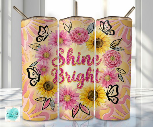 Three floral tumblers with 'Shine Bright' text on a light background