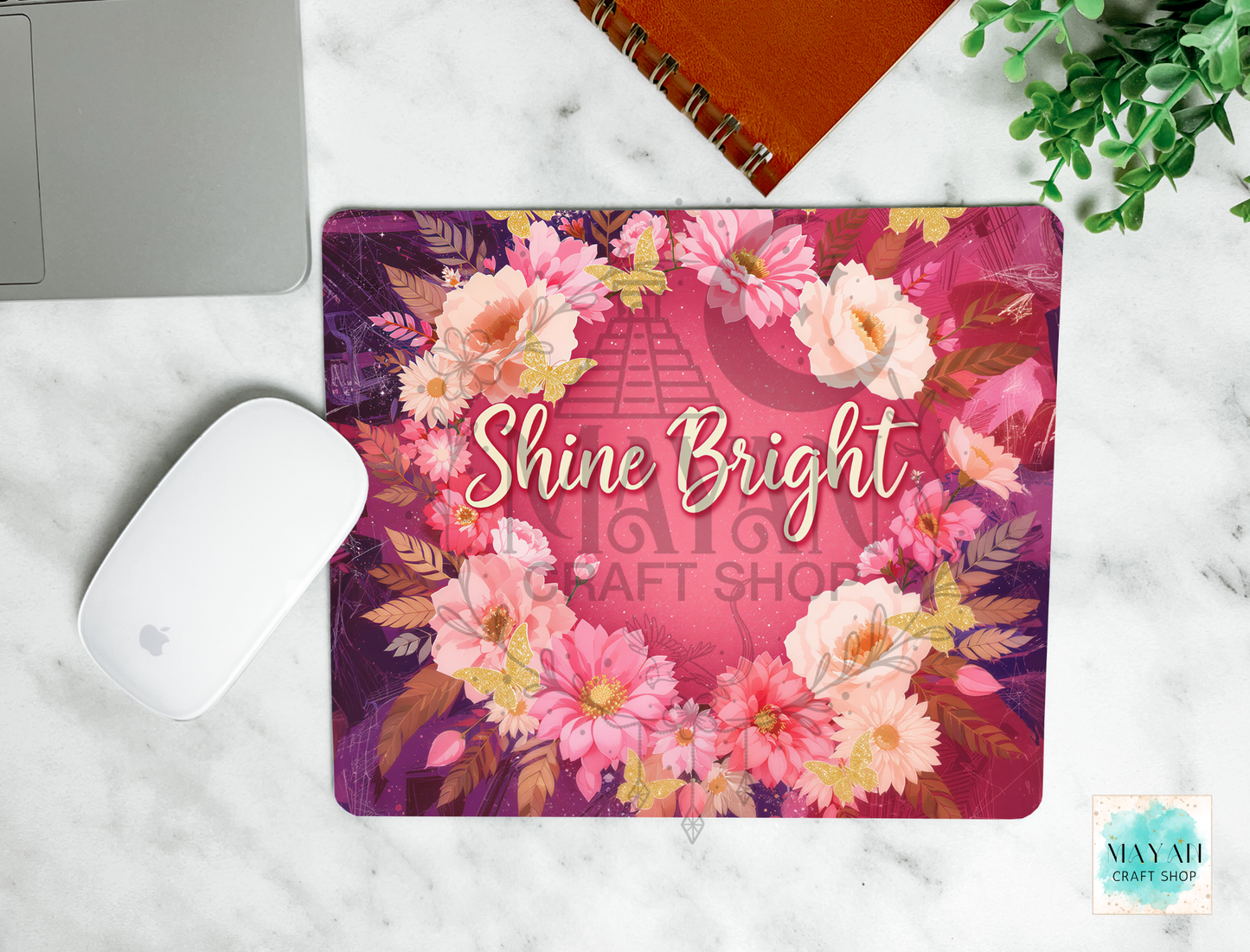 Floral mouse pad with 'Shine Bright' text on a marble surface