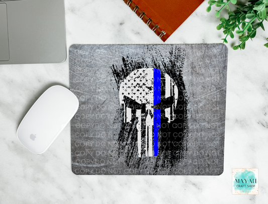 Mouse pad with Punisher skull design and blue line on a marble surface