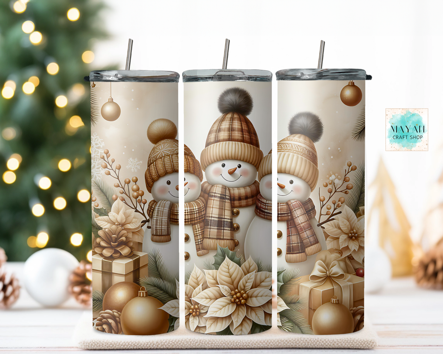Three tumblers with snowman design on a decorative background