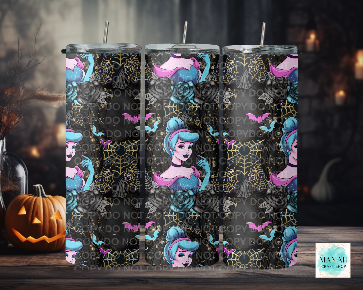 Three tumbler cups with Halloween-themed designs featuring a character with blue hair and pink accents, surrounded spider webs. The background is dark.