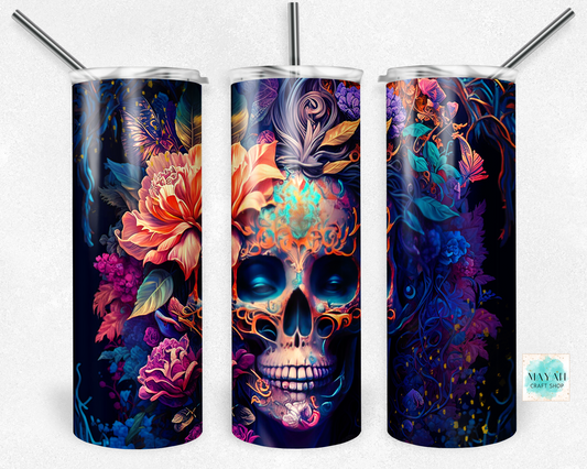 Three colorful tumblers with skull and floral designs on a white background