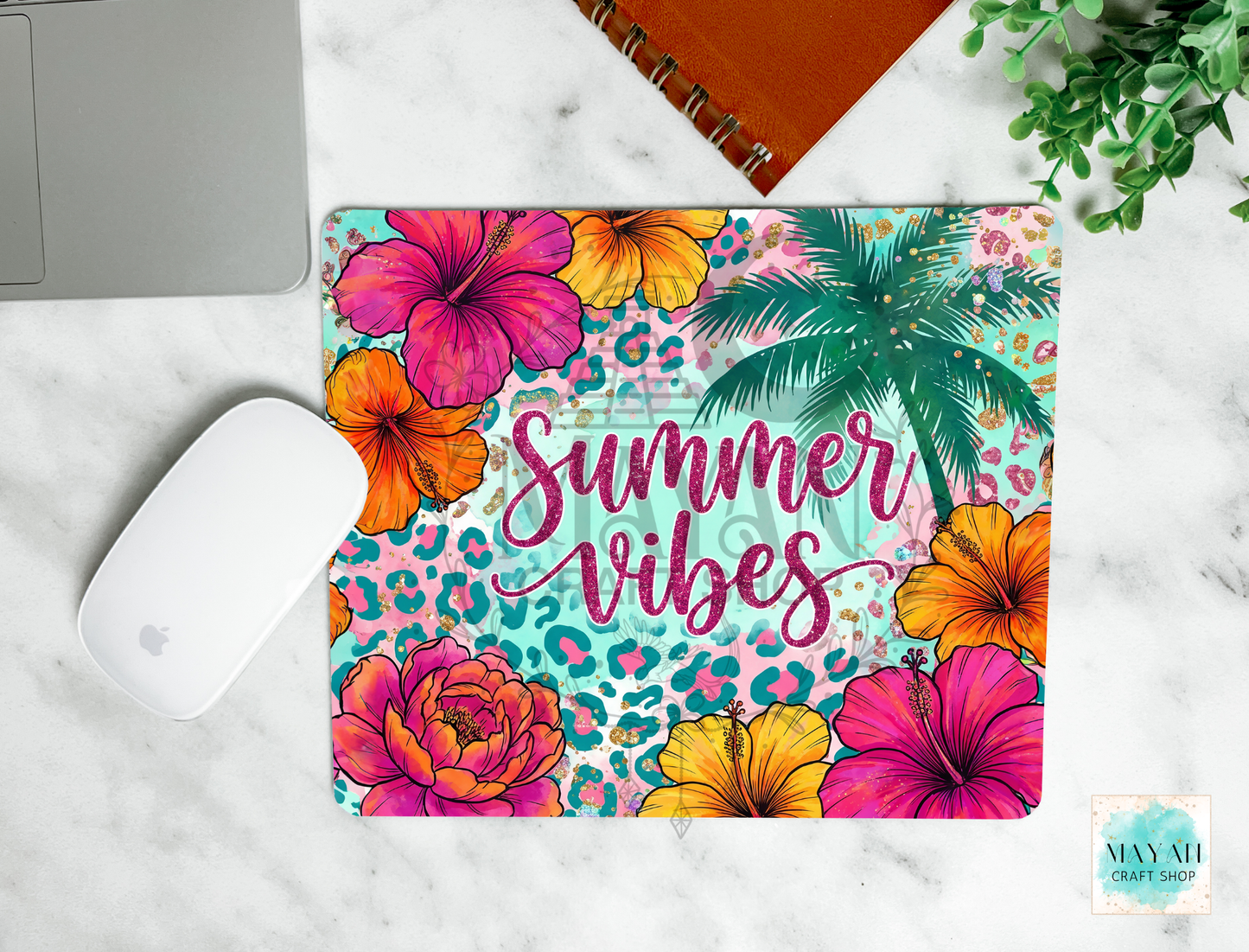 Colorful mouse pad with tropical flowers and 'Summer Vibes' text on a marble surface.