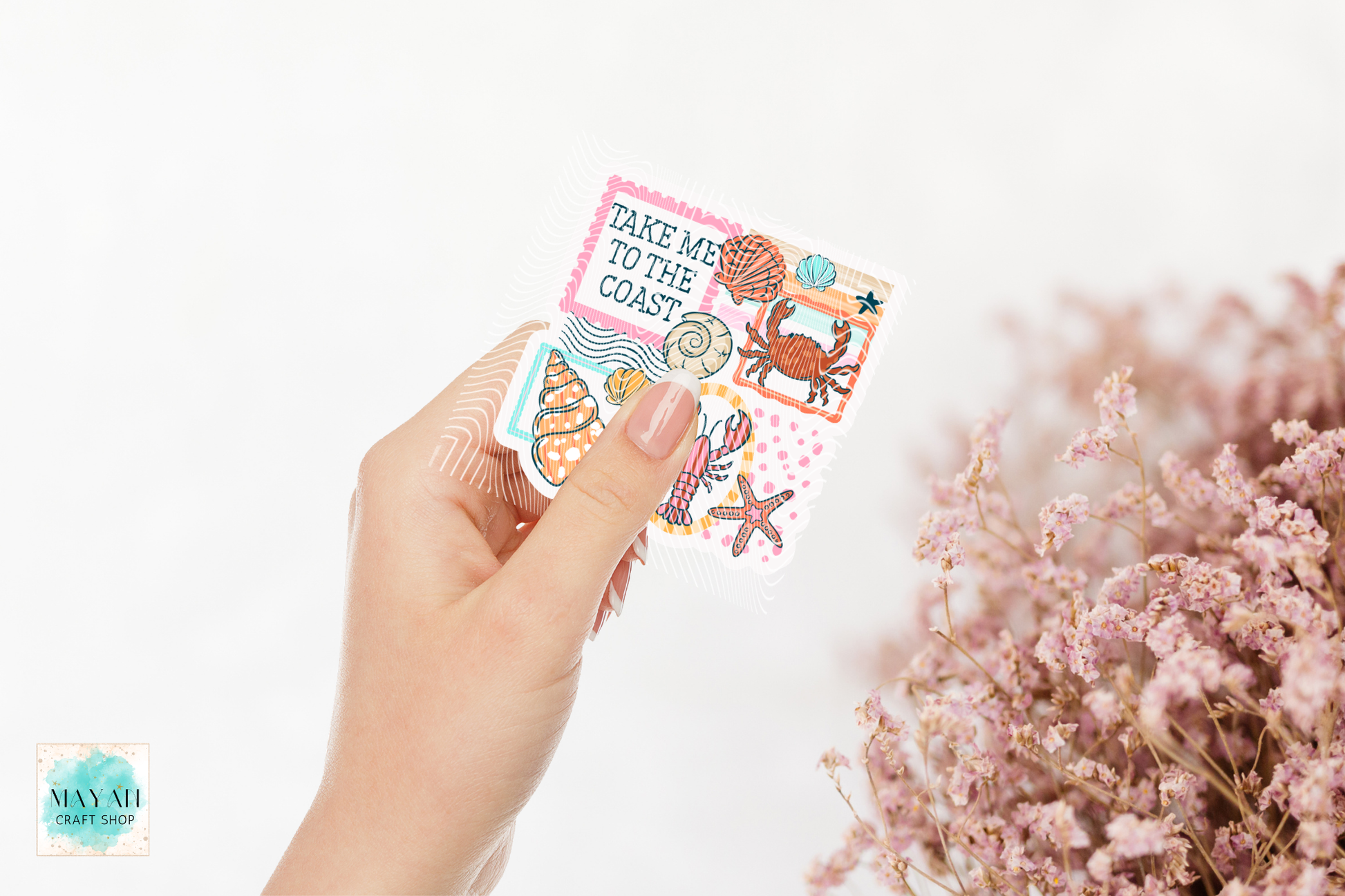 Hand holding a pack of decorative stickers with ocean-themed designs on a light background.