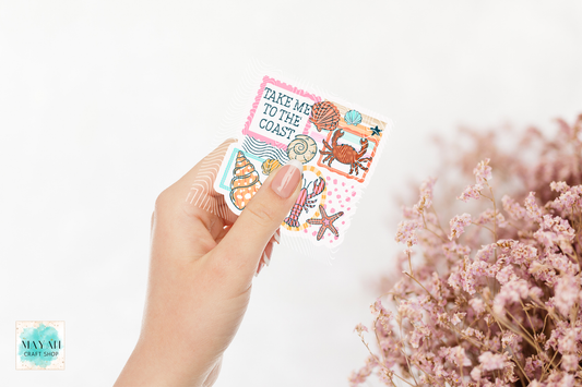 Hand holding a pack of decorative stickers with ocean-themed designs on a light background.