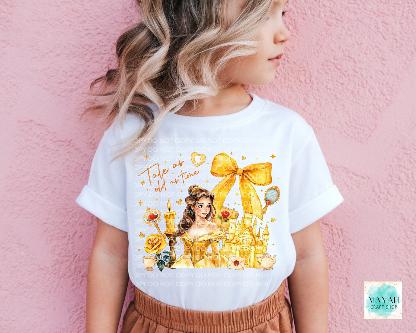 Child wearing a white t-shirt with a princess graphic design against a pink background.