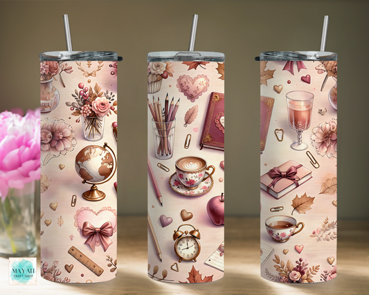 Three tumblers with decorative patterns featuring flowers, books, and tea cups on a neutral background.
