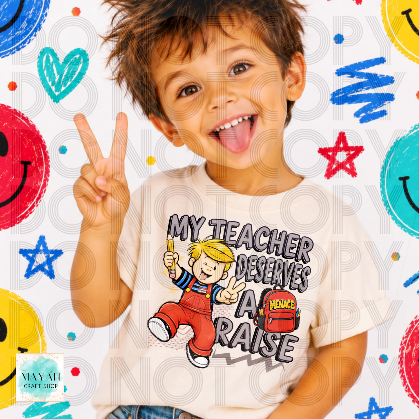 A young boy with brown hair smiling and sticking out his tongue, making a peace sign. He is wearing a cream-colored t-shirt with a cartoon graphic of a boy in red overalls and the text 'MY TEACHER DESERVES A RAISE'.