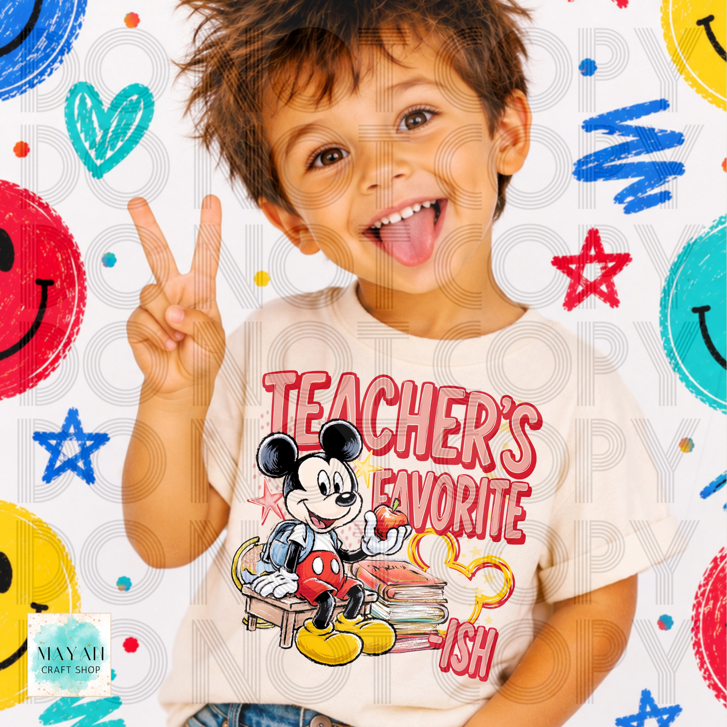 A young boy smiling and making a peace sign while wearing a cream-colored graphic t-shirt with a cartoon and the text 'TEACHER'S FAVORITE'. The background is a playful white pattern with colorful faces, stars, and scribbles.