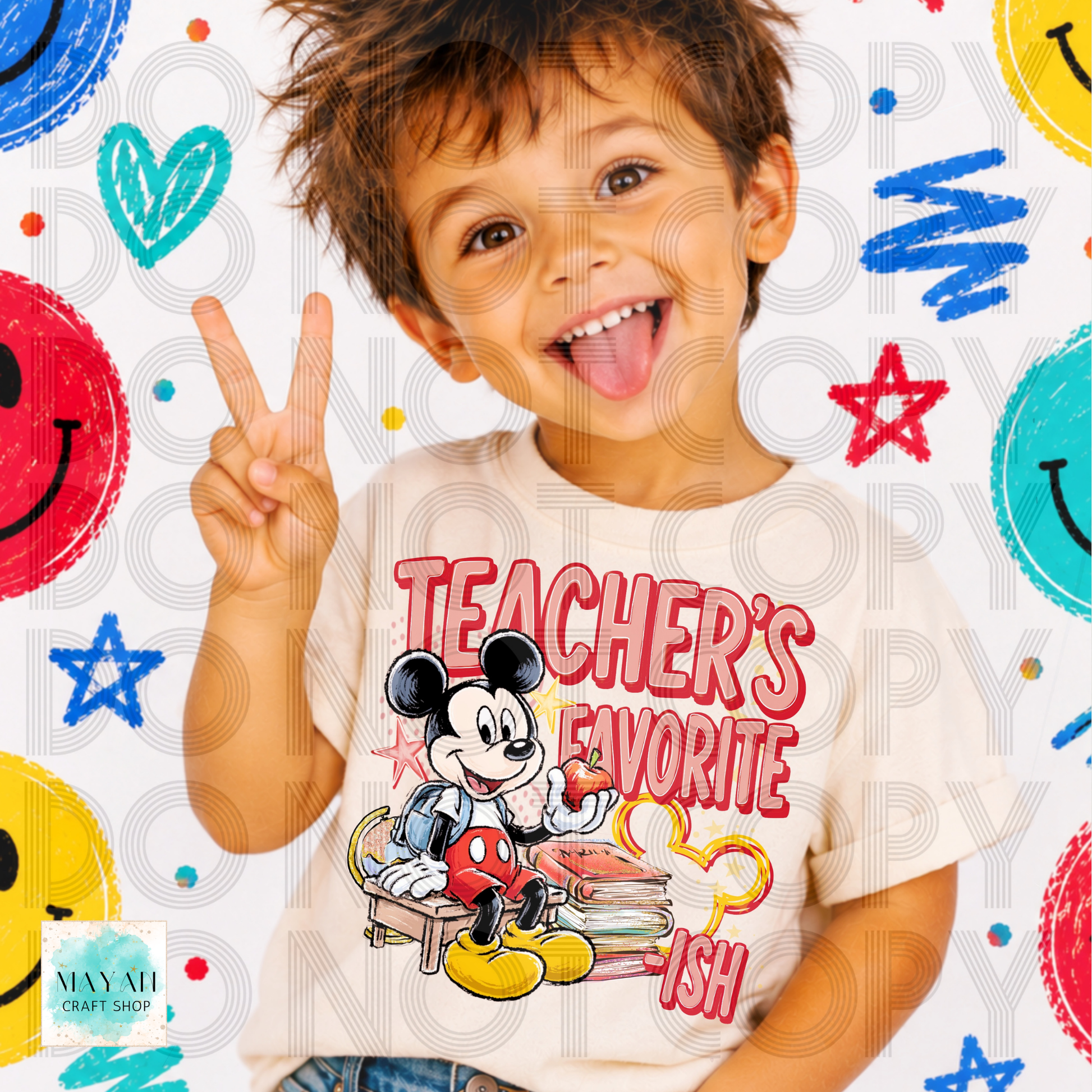 A young boy smiling and making a peace sign while wearing a cream-colored graphic t-shirt with a cartoon and the text 'TEACHER'S FAVORITE'. The background is a playful white pattern with colorful faces, stars, and scribbles.