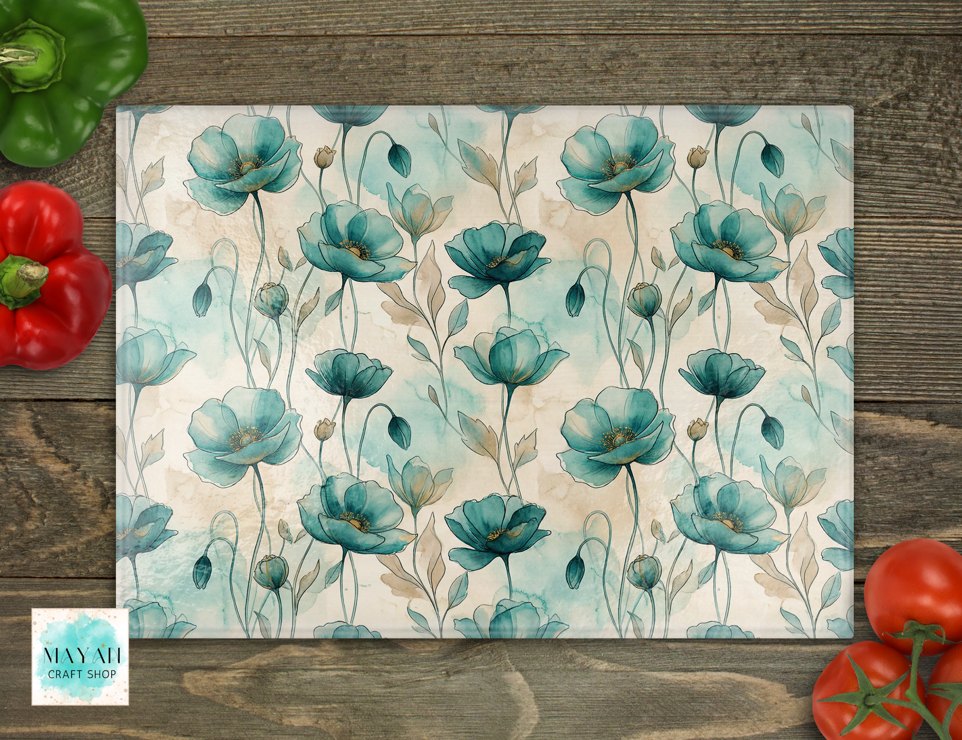 Cutting board with teal flowers on a wooden surface with vegetables.