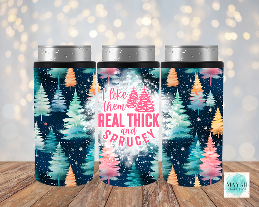 Three tumblers with Christmas tree design and text on a wooden surface with a bokeh background.