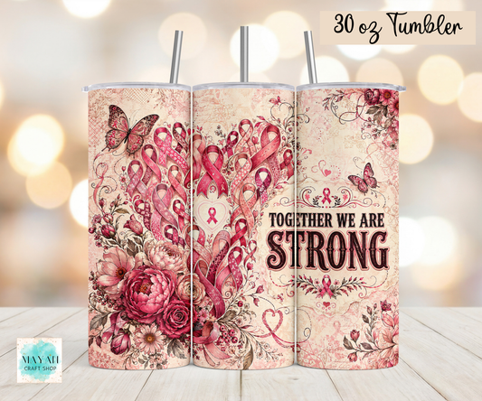 Three 30 oz tumblers with metal straws, featuring a pink and red ribbon awareness floral design with butterflies and the text 'TOGETHER WE ARE STRONG' on a cream background. 