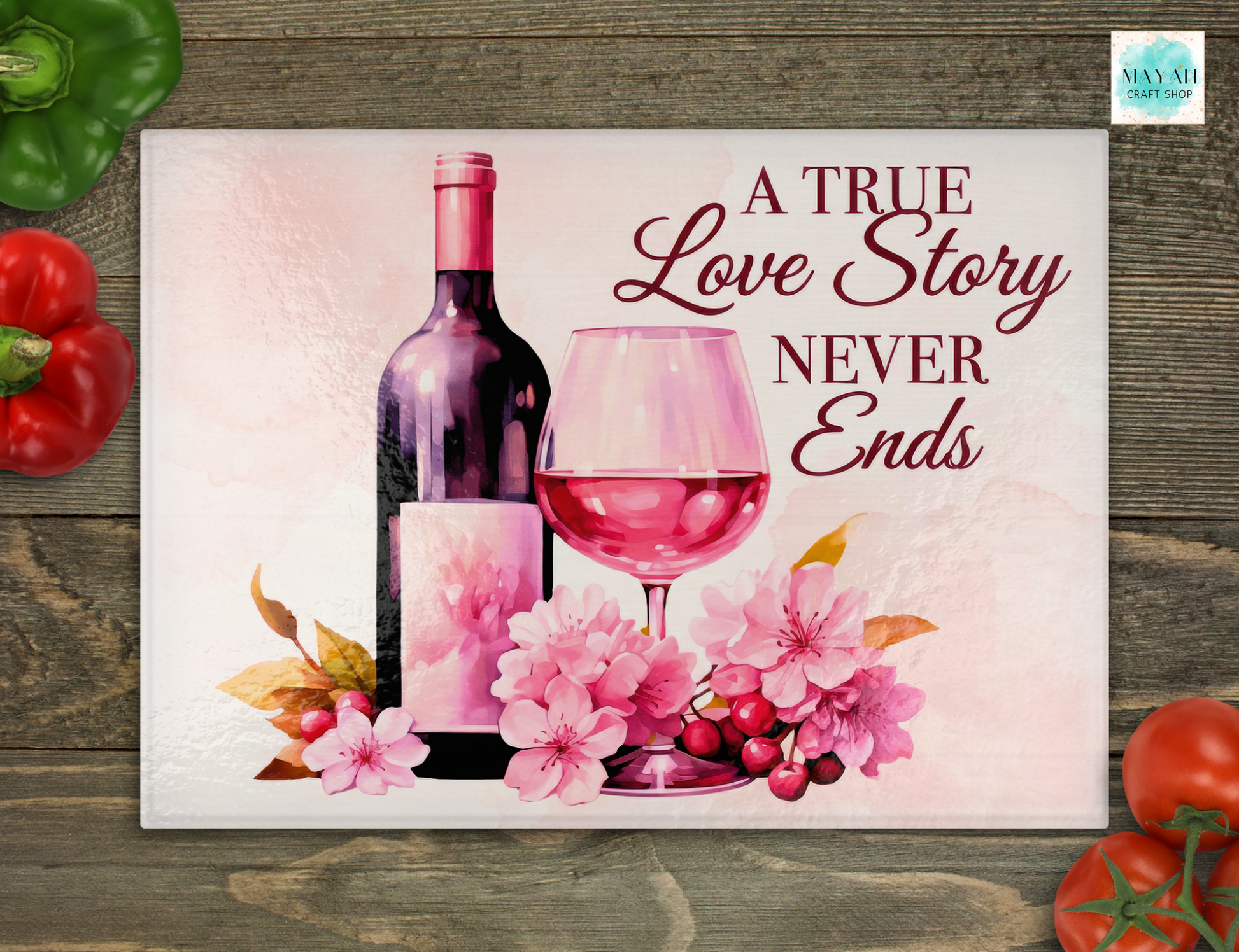 Decorative card with wine bottle, glass, flowers, and text 'A True Love Story Never Ends' on a wooden surface.