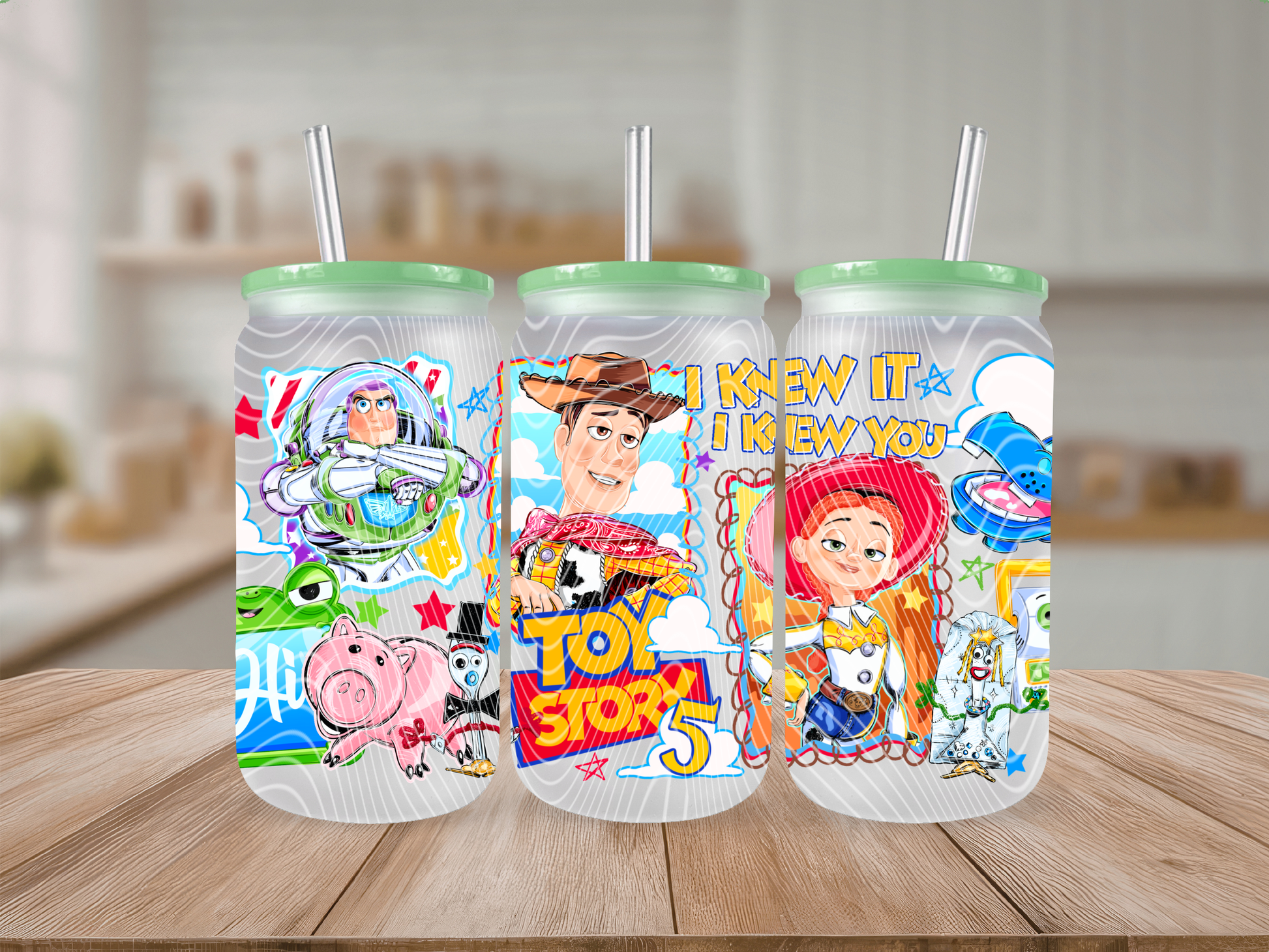Three colorful tumblers with characters on a wooden table.