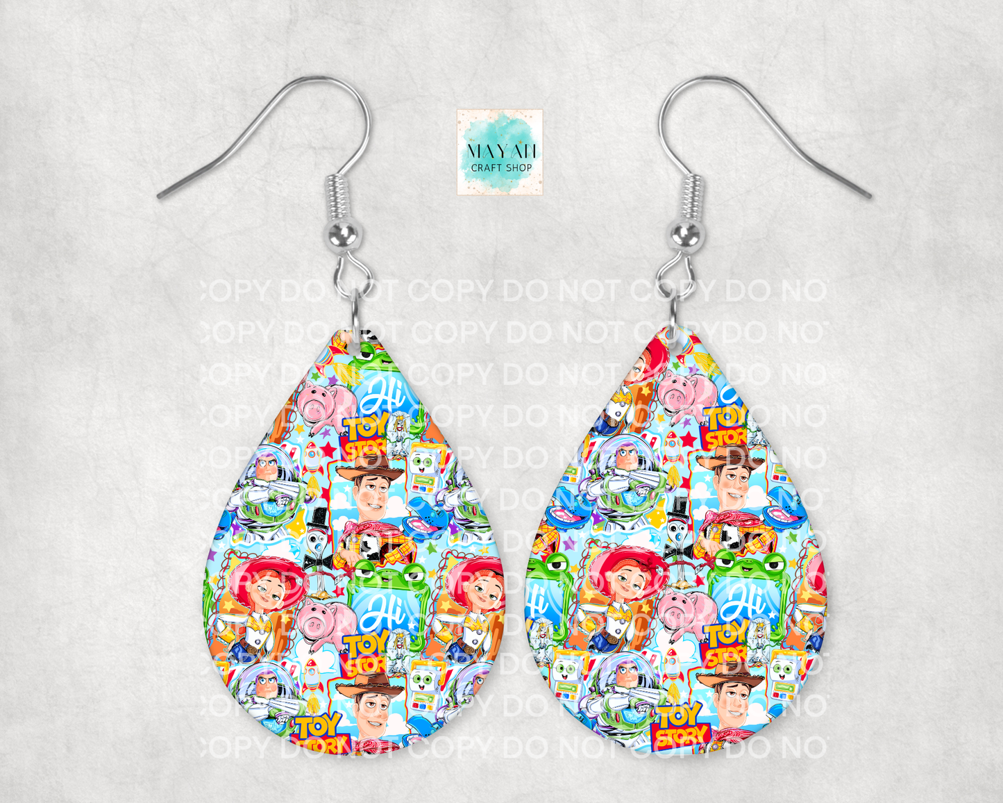 Teardrop-shaped earrings with colorful character pattern on a light gray background