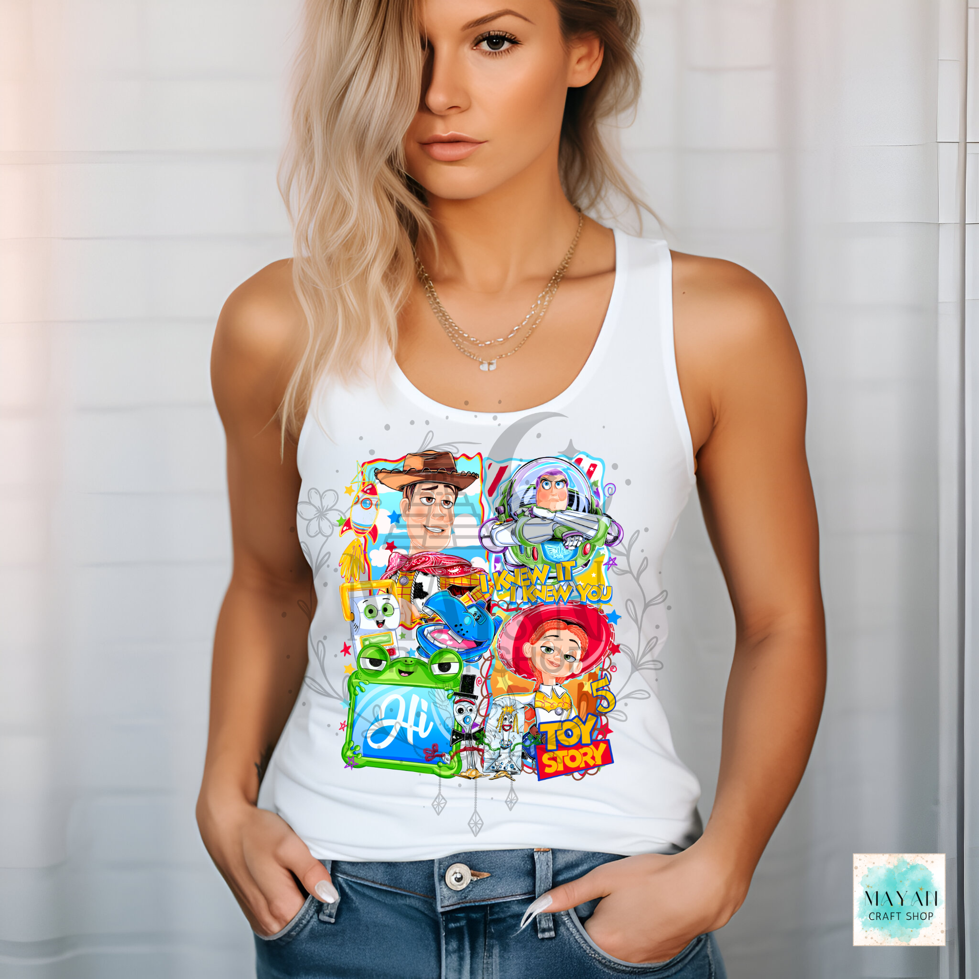 Woman wearing a white tank top with  character graphics against a light background