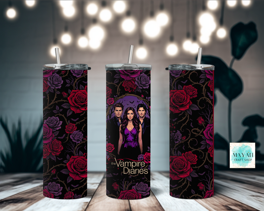 Three tumblers with tv show design on a wooden surface with blurred lights in the background.