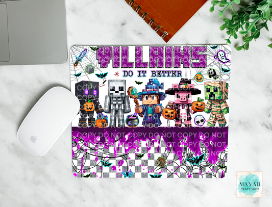 Halloween-themed mouse pad with characters and text on a marble surface.