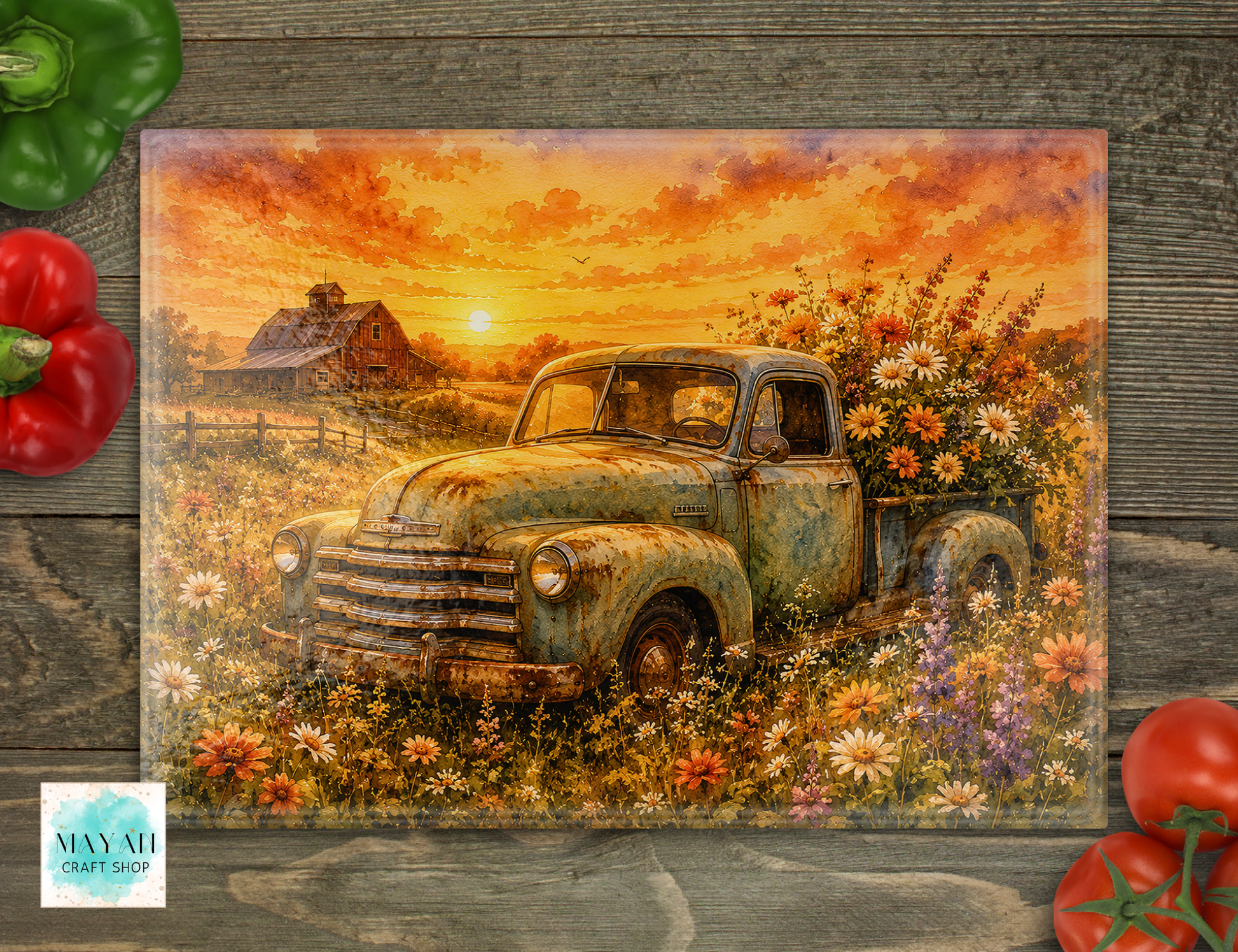 Cutting board with an old truck and sunset over a field design, placed on a wooden surface with vegetables.